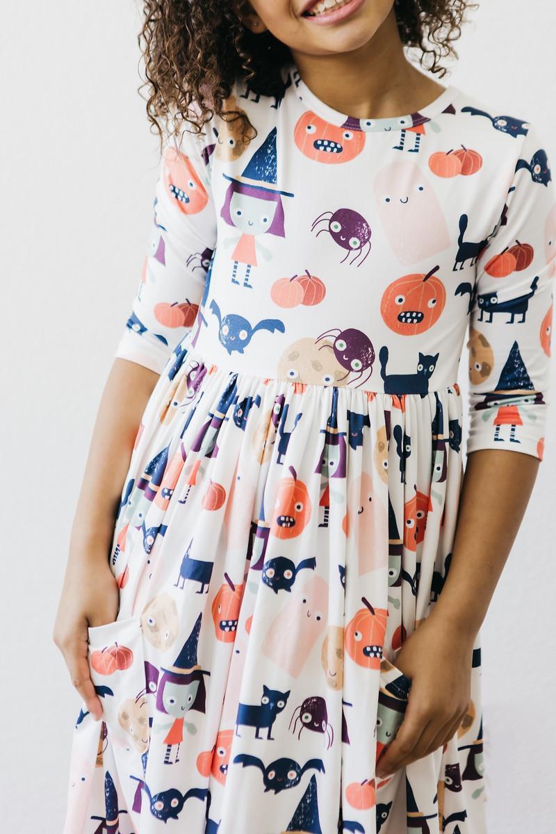 Close-up of the Boo Crew print across the bodice and skirt, worn by a girl.