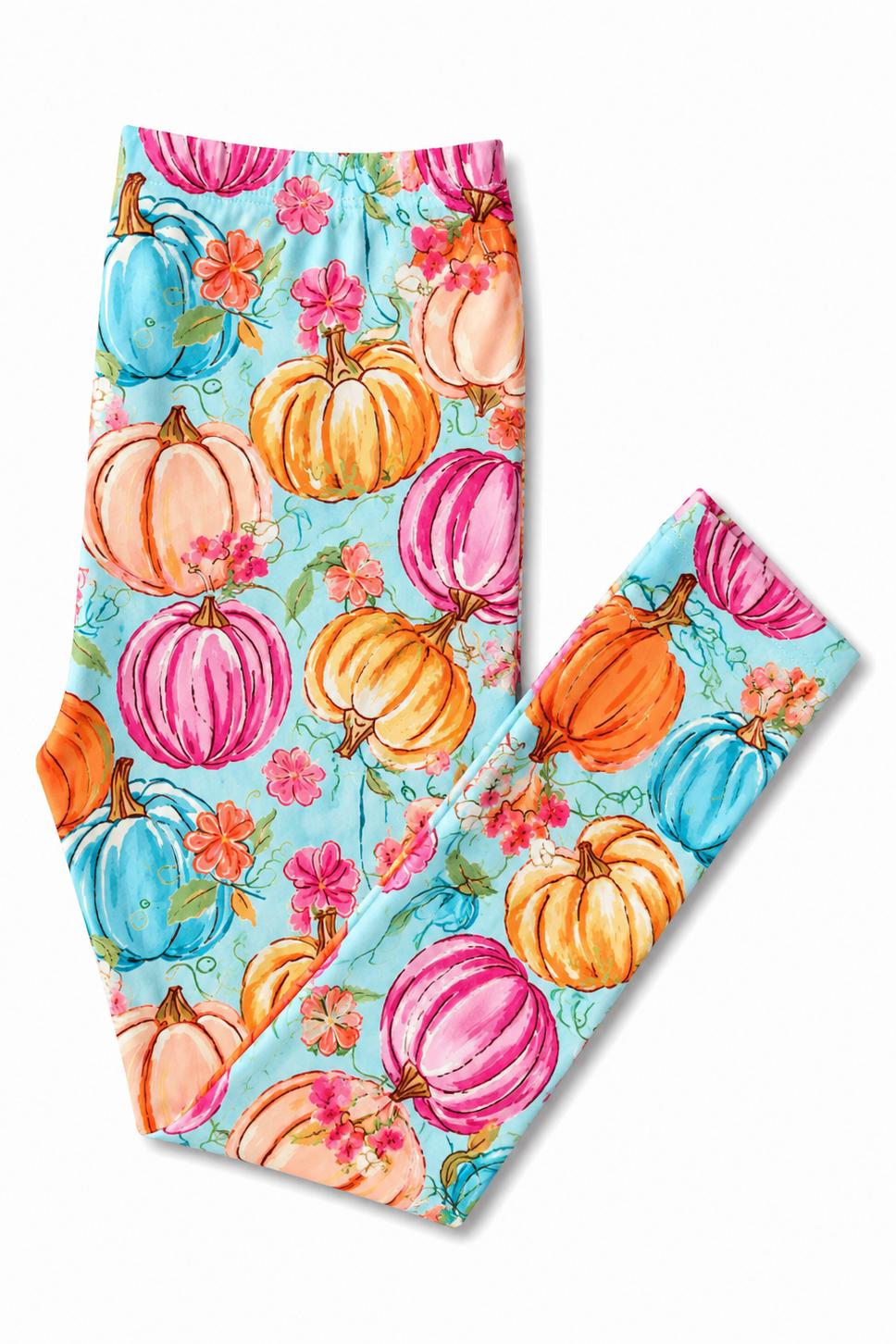 Flat lay of the Mila & Rose Preppy Pumpkins leggings folded to show the watercolor pumpkins in orange, pink, peach and blue with pink blossoms on a light blue ground.