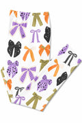 Flat lay of the Tied with a Boo leggings folded to show the printed bows in purple, orange, olive and black on white.