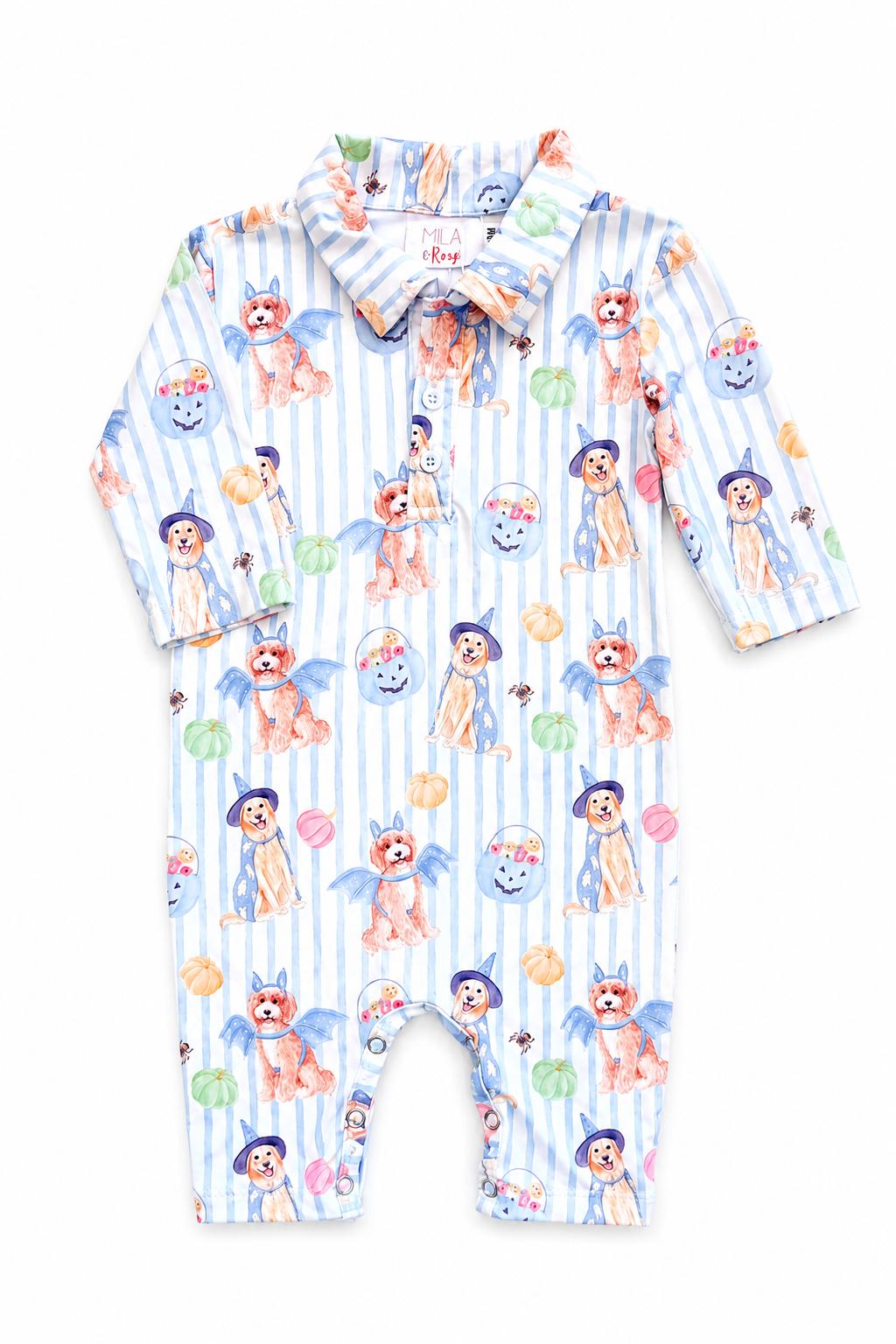 Flat lay of the Mila & Rose Pawsitively Spooky boys' long-sleeve polo one-piece, folded to show watercolor puppies in witch hats and bat wings with jack-o'-lantern candy buckets on a light blue stripe.