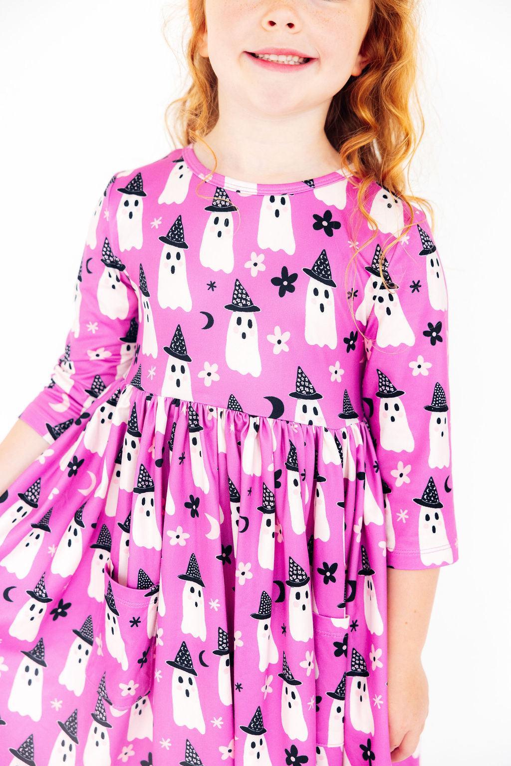 Close-up of the Witches Boo dress on a girl, showing the sleeve and gathered waist.