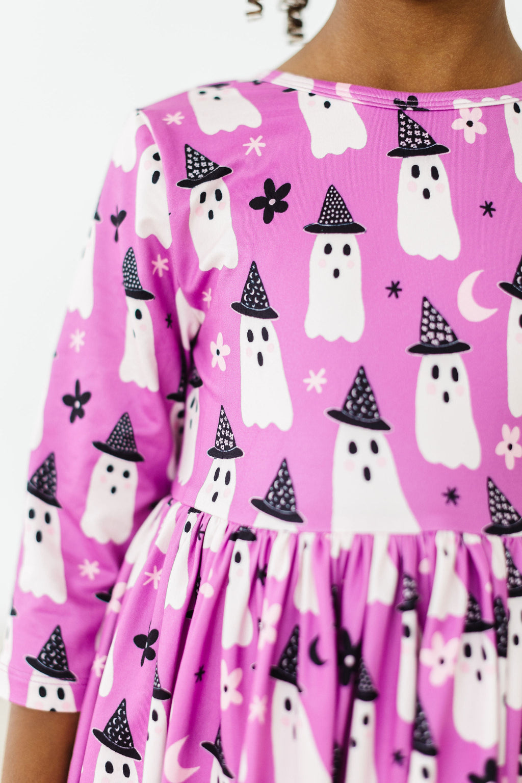 Close-up of the Witches Boo print: white ghosts in black witch hats with daisy flowers and moons on a bright purple ground.