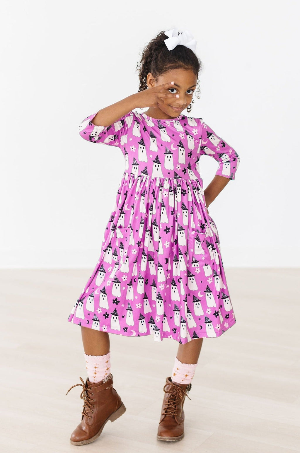 Full-length view of the Witches Boo twirl dress on a girl in a Halloween display.